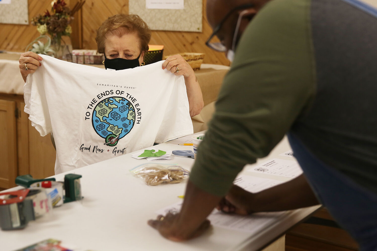 Madonna Zander finds the right sized shirt for volunteer Gabryl Lewis